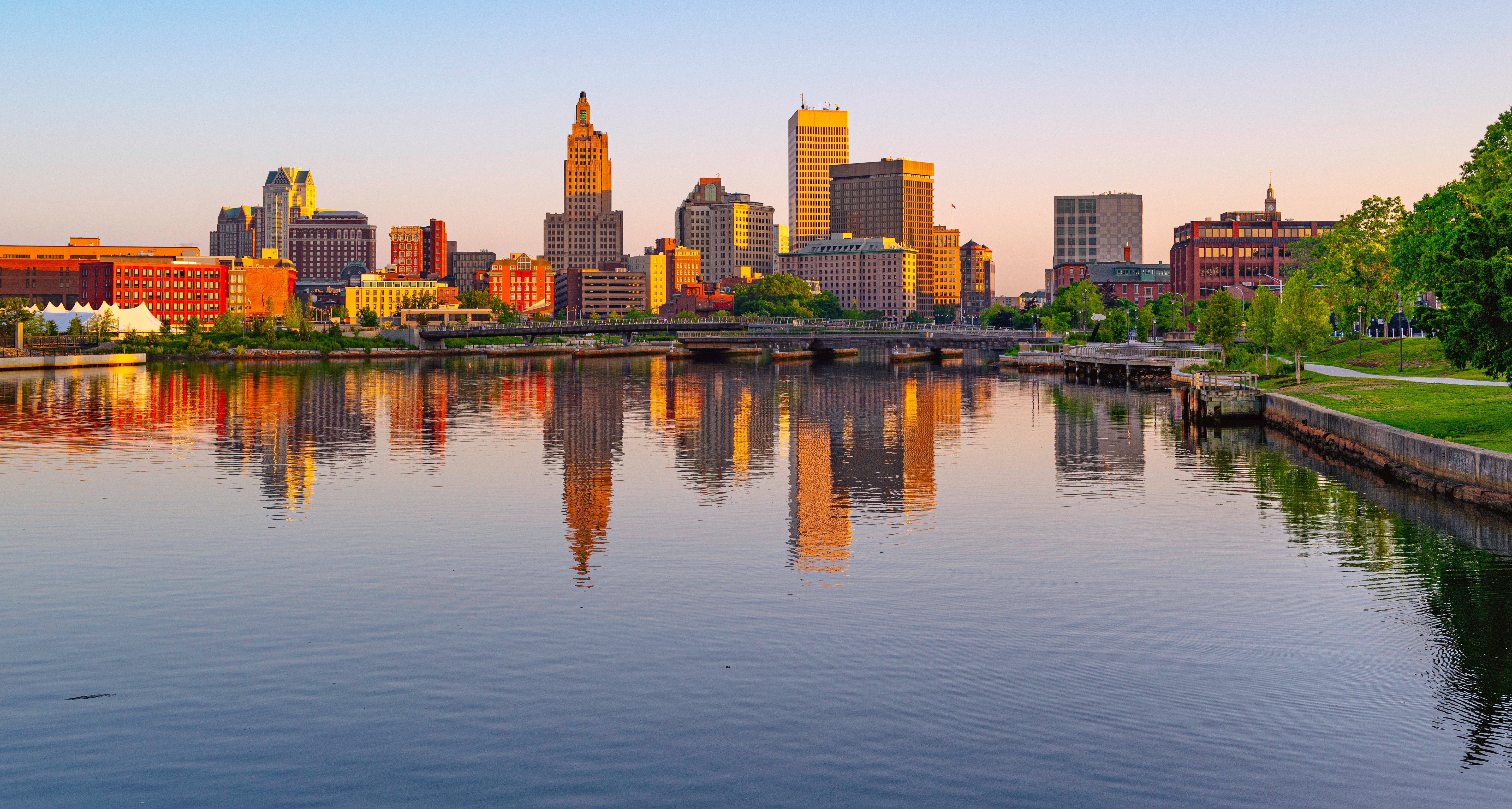 The Providence, Rhode Island skyline at golden hour reflected in the river